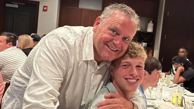Harding Academy linebacker Wyatt Simmons with Arkansas coach Sam Pittman on a visit.